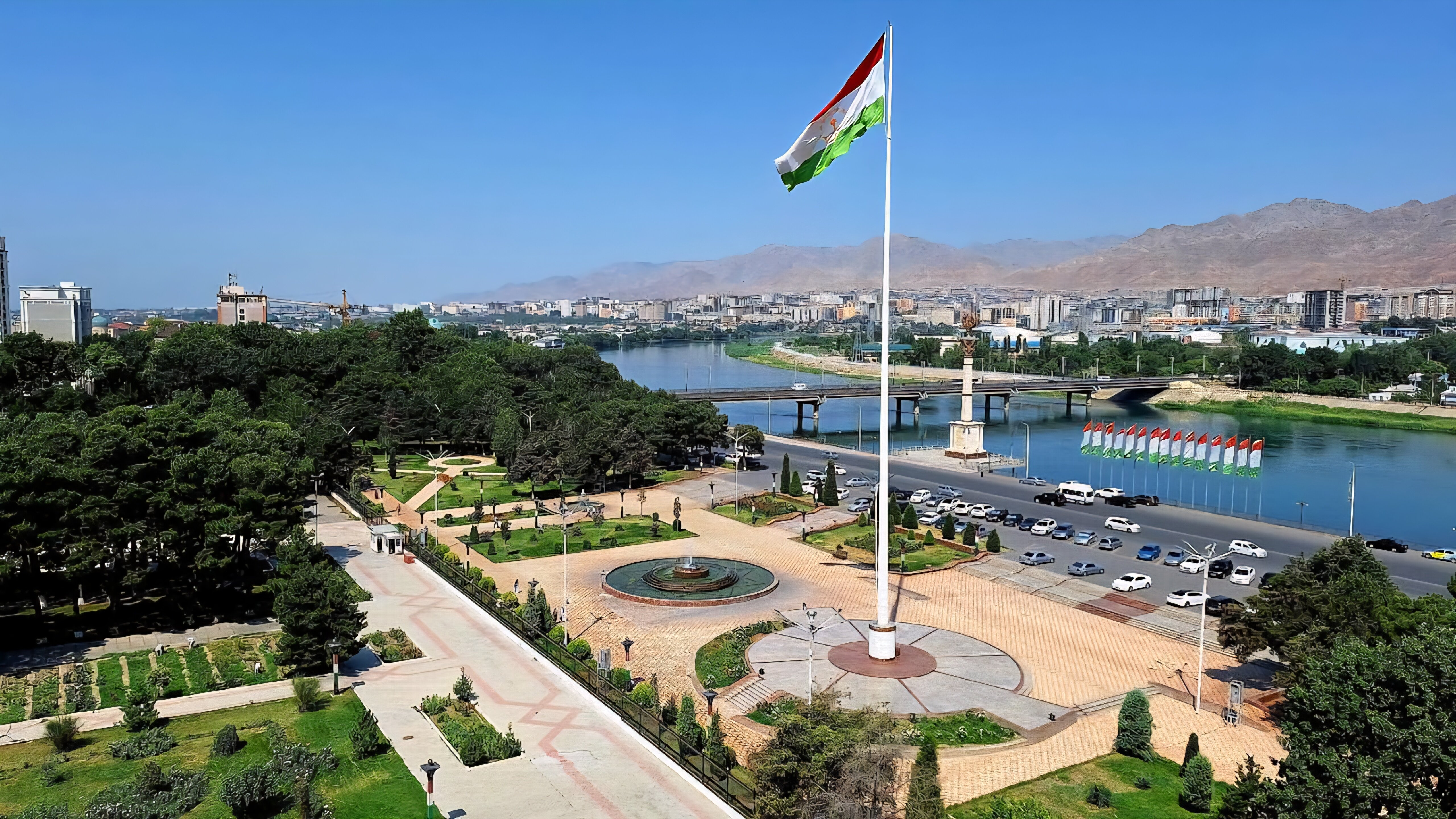 The Tajikistan flag above the Syr Darya river and Khujand skyline
