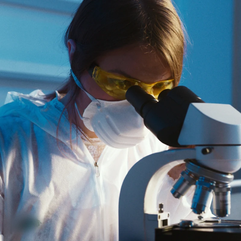 A researcher using a microscope in a laboratory